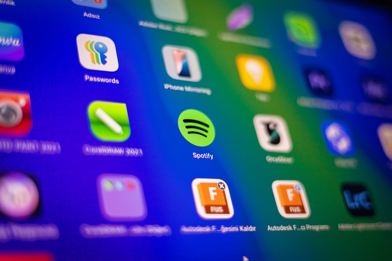 Blurred close-up of vibrant app icons on a smartphone screen showcasing Spotify and more.